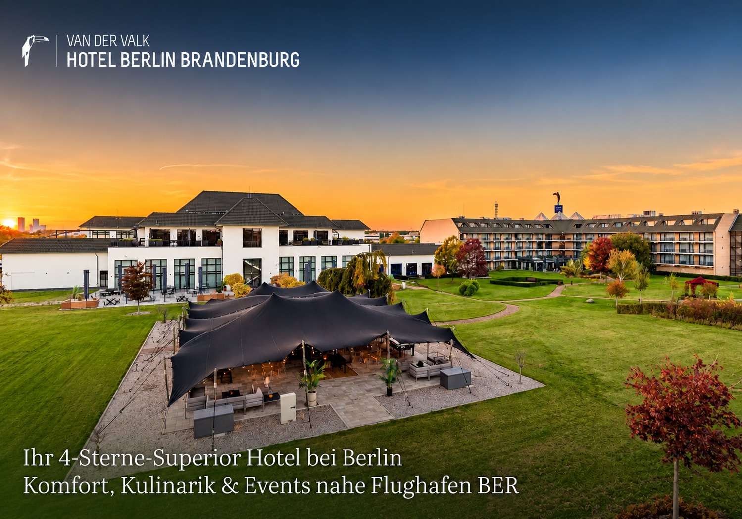 Van der Valk Hotel Berlin Brandenburg mit Gartenanlage und Eventzelt bei Sonnenuntergang